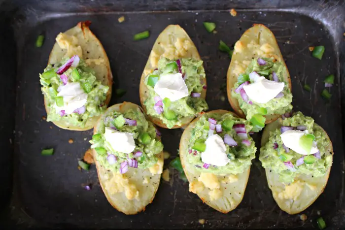 potato halves with melted cheese and guacamole