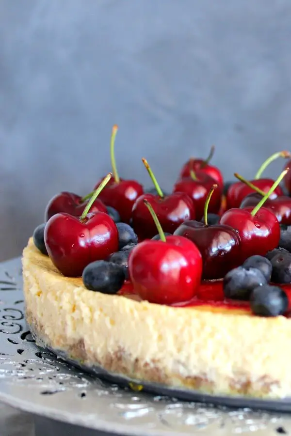 Baked Vanilla Cheesecake with Cherry Coulis. You won't believe how creamy & melt in your mouth this baked cheesecake is! It's super easy to make & absolutely perfect as a Christmas dessert | berrysweetlife.com