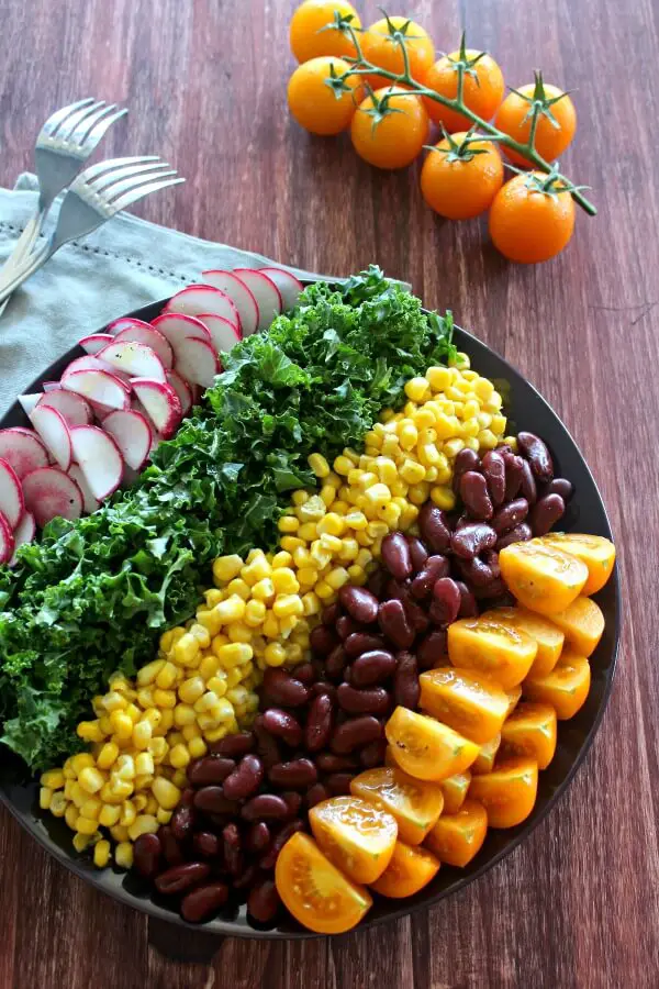 Mexican Chopped Corn, Vine Tomato & Kale Salad. A simple & tasty recipe with a Lemon & Honey Olive Oil Dressing. Perfect for a light lunch or as a side salad. The whole family will love this! | berrysweetlife.com