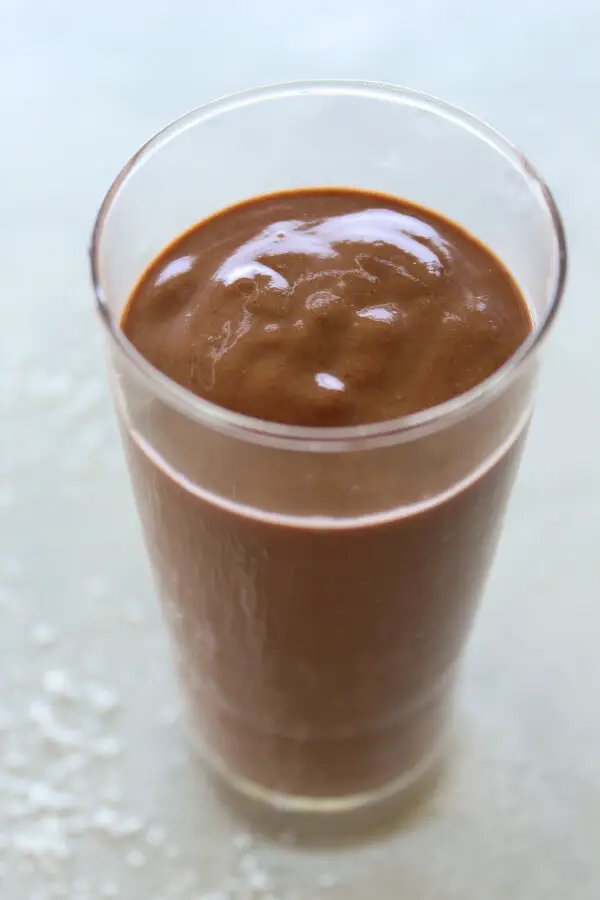 A super chocolatey, thick and creamy, healthy Chocolate Cinnamon Coconut Smoothie made with cocoa powder, bananas, dates, coconut milk. Dairy free, vegan | berrysweetlife.com