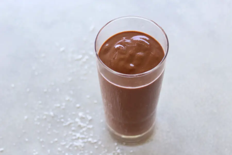 A super chocolatey, thick and creamy, healthy Chocolate Cinnamon Coconut Smoothie made with cocoa powder, bananas, dates, coconut milk. Dairy free, vegan | berrysweetlife.com