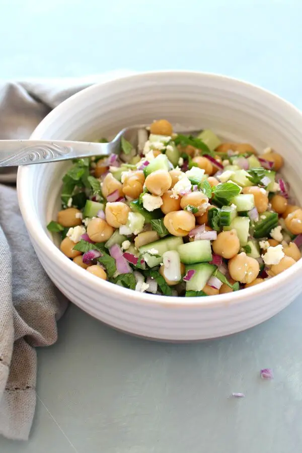 A heavenly combination! This easy Clean Eating Cucumber Mint Chickpea Salad salad is made with cucumber, mint, chickpeas, red onion, feta and almonds | berrysweetlife.com